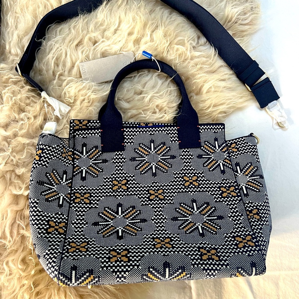 Rothy’s “the Handbag” Sunburst Navy. Brand new. Includes strap and dust bag.